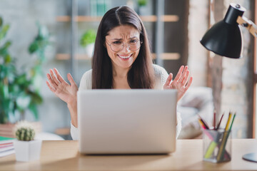 Photo of upset woman sit table have work problem wear spectacles white pullover in living room home...
