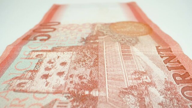 A closer look of the back of the 500 Hungarian forint bill laid on the white table 