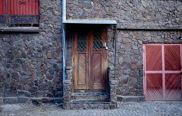 old wooden door in house, wooden door with forged metal elements, iron handle, vintage objects,...