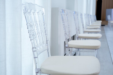 Clear plastic chiavari chairs in vintage style at weddings or events that maintain social distance and prevent the spread of COVID-19.