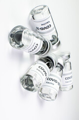 Coronavirus vaccine bottle flipped isolated on black background. Covid-19 situation disease pharmacy in laboratory and drug to cure people.  Healthcare and Medical concept. Development of research.