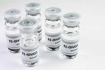 Coronavirus vaccine bottle flipped isolated on black background. Covid-19 situation disease pharmacy in laboratory and drug to cure people.  Healthcare and Medical concept. Development of research.