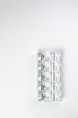 Coronavirus vaccine bottle flipped isolated on black background. Covid-19 situation disease pharmacy in laboratory and drug to cure people.  Healthcare and Medical concept. Development of research.