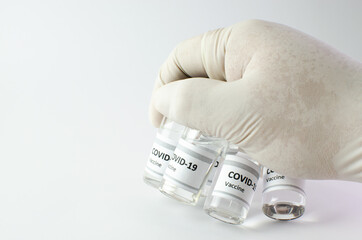 Coronavirus vaccine bottle flipped isolated on black background. Covid-19 situation disease pharmacy in laboratory and drug to cure people.  Healthcare and Medical concept. Development of research.