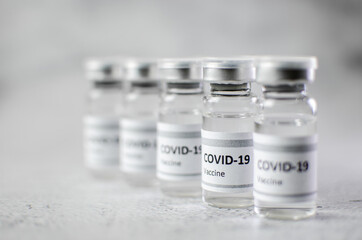 Coronavirus vaccine bottle flipped isolated on black background. Covid-19 situation disease pharmacy in laboratory and drug to cure people.  Healthcare and Medical concept. Development of research.