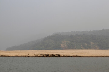 White stone and sands behind the hills and trees