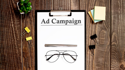 Ad Campaign text form on the wooden table.