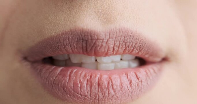 Close up of sensual female mouth biting lips