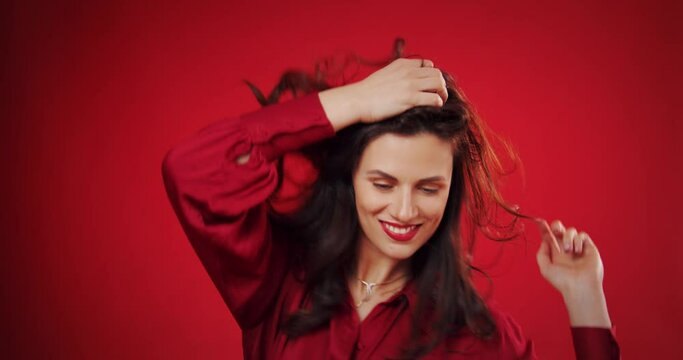 beautiful woman dancing to music over red background 