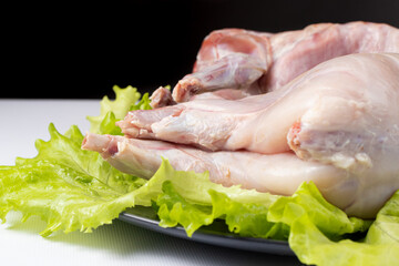 Raw rabbit meat, cooking meat, meat on lettuce