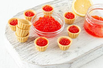 Tartlets with butter and red caviar. Gourmet food, appetizer. Delicatessen. Seafood.