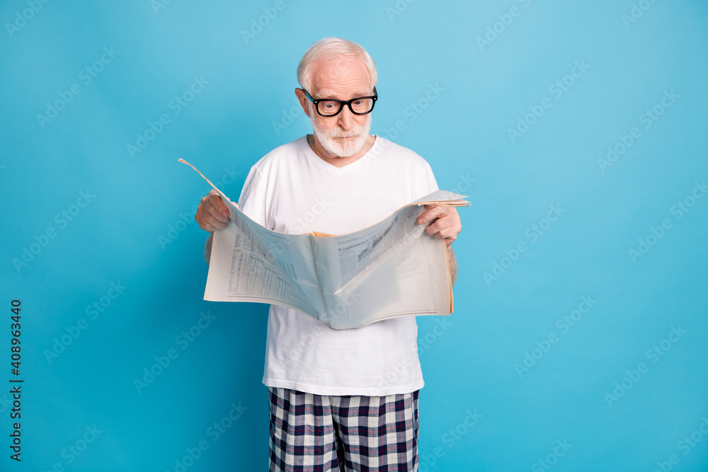 Sticker Portrait of aged person arms holding newspaper read unbelievable news isolated on blue color background