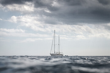 View of a sail yacht in Philippines from a water level on a cloudy day