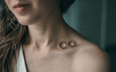 Wedding rings on the bride's collarbone. The concept of celebrating Valentine's Day