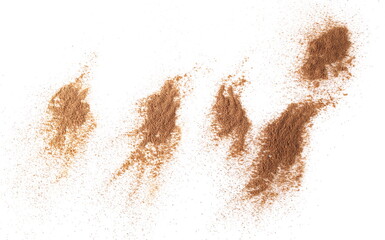 Fototapeta na wymiar Cinnamon powder piles isolated on white background, top view