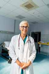 Portrait of a smiling medical mature doctor woman with stethoscope. Healthcare, people concept