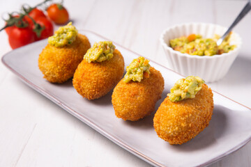 Traditional spanish croquettes tapas with avocado. Veggie tapa.