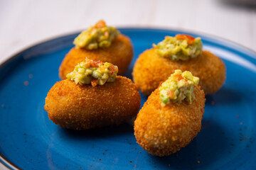 Traditional spanish croquettes tapas with avocado. Veggie tapa.