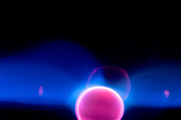 Plasma electric ball lightning lamp. Fascinating space video, close-up of electrical discharges with blue flames on a dark background