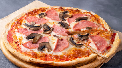Pizza with ham and mushrooms. Closeup