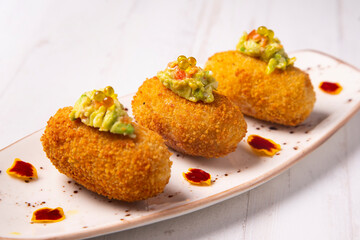 Traditional spanish croquettes tapas with avocado. Veggie tapa.