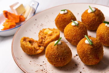 Traditional spanish croquettes from mallorca with sobrassada and cheese