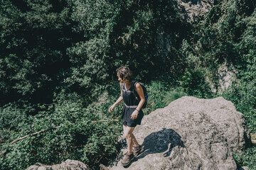 Girl walking along a small path in the mountain of Prades, Tarragona, Spain.