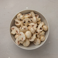 Fresh sliced mushrooms in a round porcelain bowl