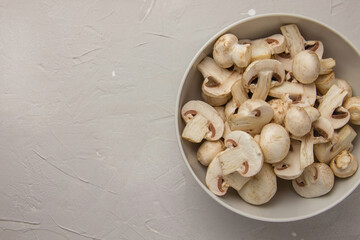 Whole and chopped fresh mushrooms in a white bowl