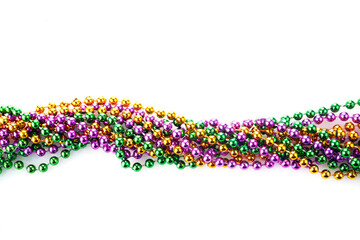 Three colour Merdi gras beads isolated on white background © vetre