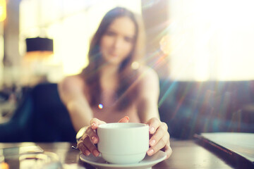 girl spring cafe portrait, happy young model posing with a cup of coffee, spring look