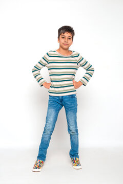 Full length portrat of attractive young boy aganst white background in studio