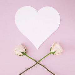 White heart shape greeting card idea with two long stem roses