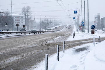 Traffic in the city. Bridge and highway. Snowfall. dirty roads and slippery