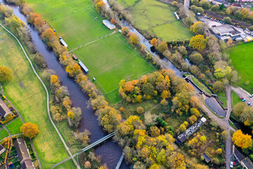 Aerial photo taken in the town of Shipley in Bradford West Yorkshire showing the Leeds & Liverpool canal taken in the Autumn time with brown leafs on the trees.