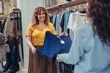 Sales woman assisting client to find a perfect outfit