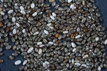Chia seeds in detail against black background