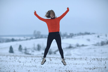 Fototapeta premium winter snow field woman happiness jumping and running in the field, new year holidays vacation freedom concept
