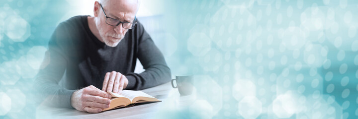 Man reading a book; panoramic banner