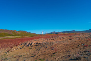 Colorful geothermal active zone Hverir near Myvatn lake in Iceland, resembling Martian red planet landscape, at summer and blue sky.