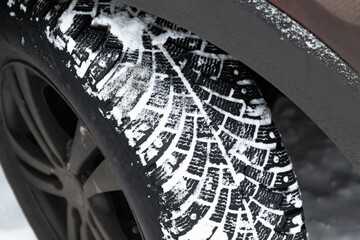 SUV car wheel. Snow tire with metal studs