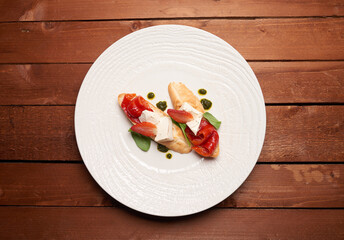 Vegetarian bruschetta with paprika cheese and strawberries on the plate on the table