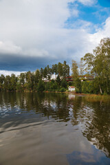 lake and forest. Small white fisherman's house on a lake with lots of trees on the beach. Lake in Sweden. Travel in Sweden 