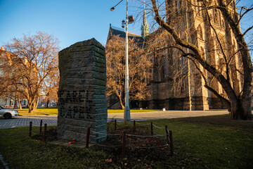 Memorial to Josef and Karel Capek at Peace Square or Namesti Miru square Vinohrady district,  gaunt three-meter-tall granite block from the Sumava mountains, Prague, Czech Republic