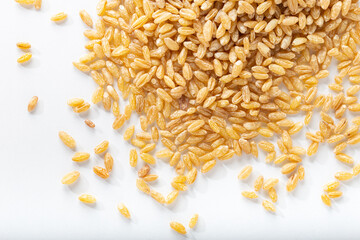 Uncooked bulgur wheat on the isolated on white background.