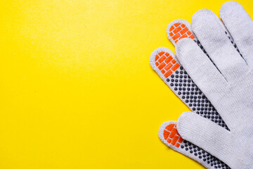 Gardening gloves on a yellow background . Work gloves on a yellow background. Yellow background. Hand protection. Copy space