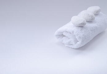 a white, terry towel with white stones on top.