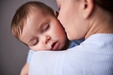 Relaxed little boy sleeping at daytime after walk