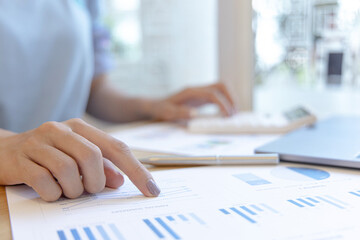 Accounting businesswomen are calculating income-expenditure and analyzing real estate investment data, Dedicated to the progress and growth of the company, Financial and tax systems concept.