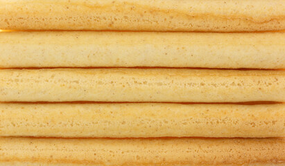 Close view of small dried breadsticks in rows.